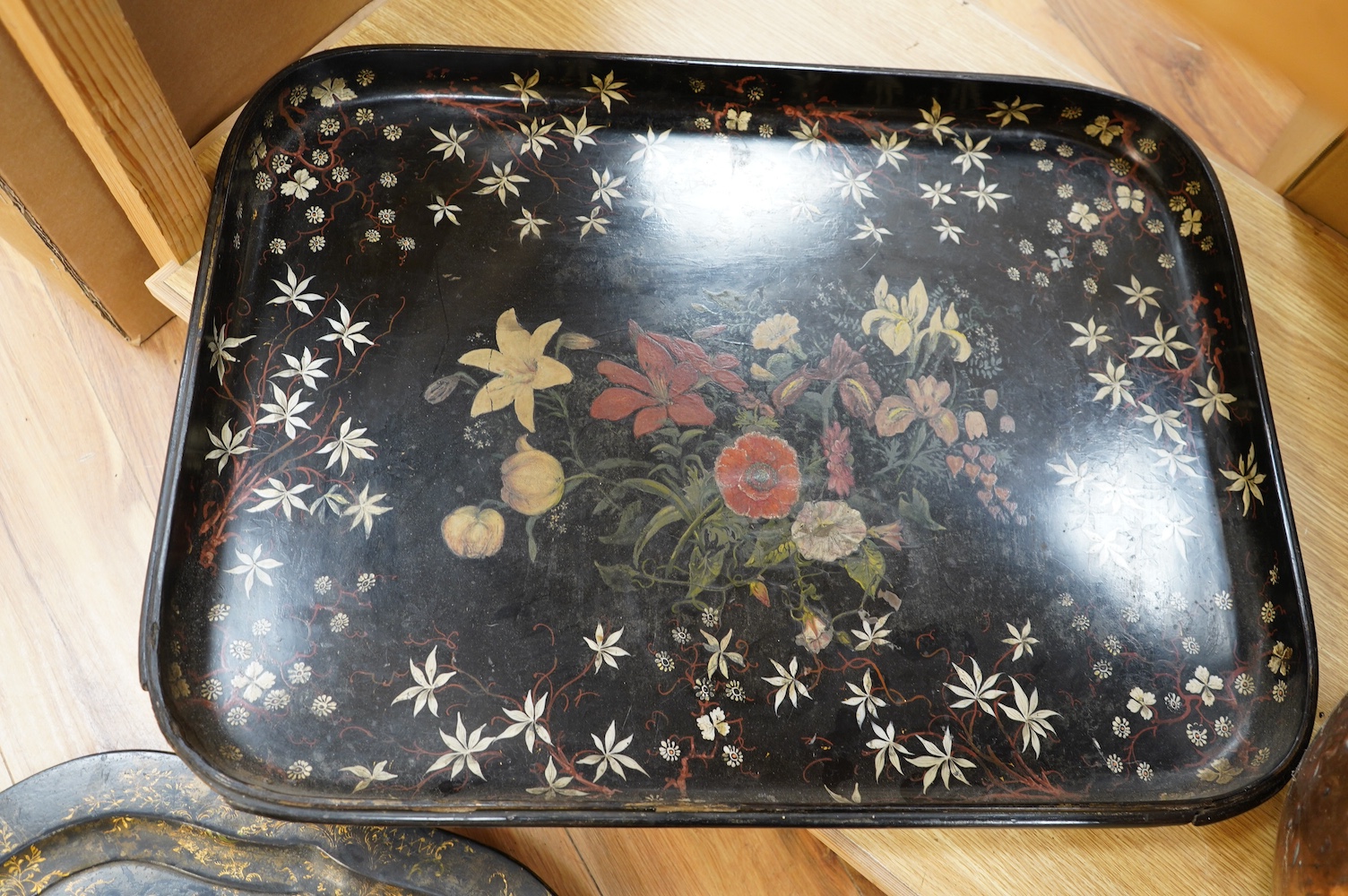 Three large Victorian papier mâché trays, largest 71cm wide. Condition - all have faults